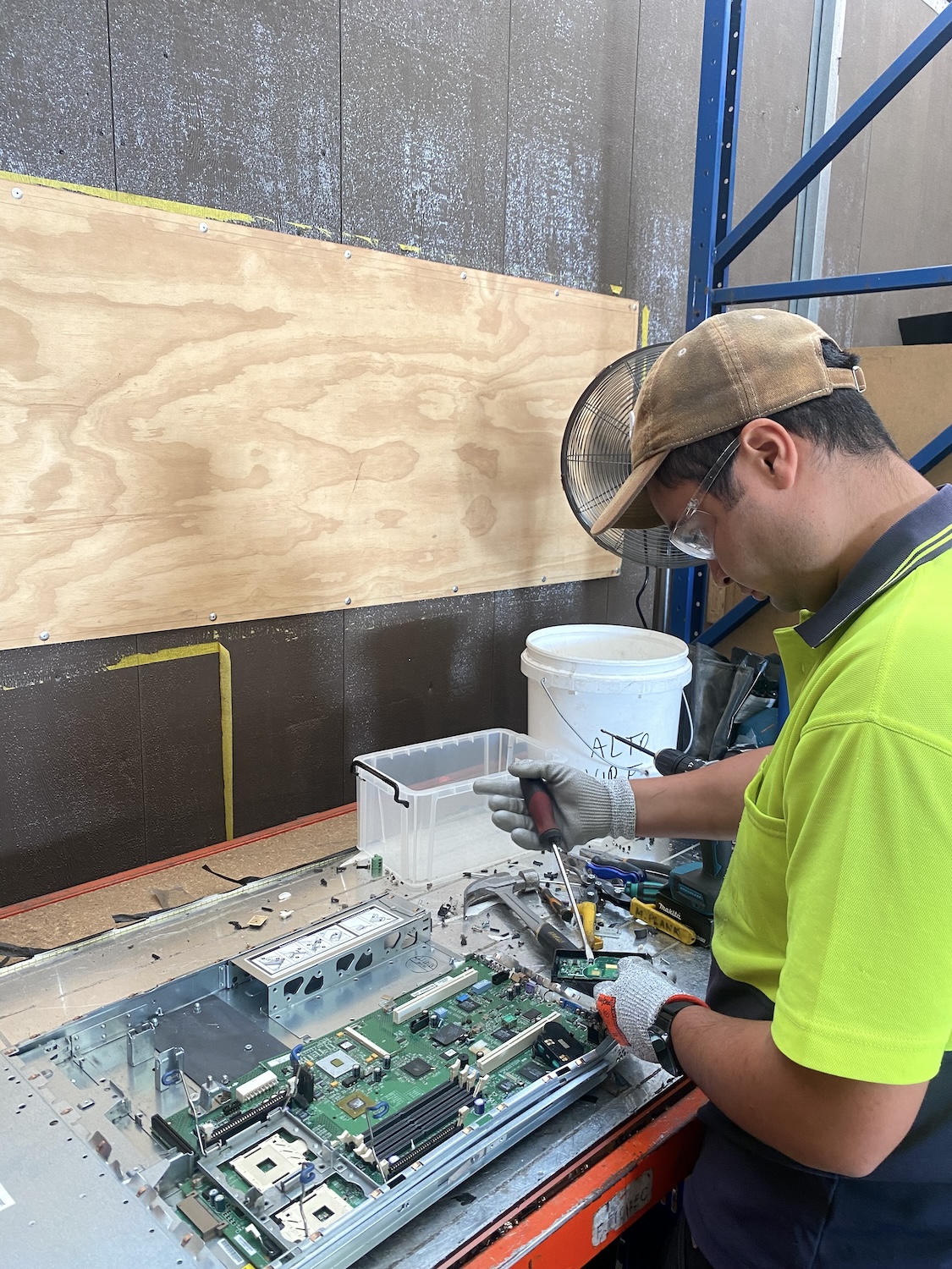 Technician disassembling electronic equipment for recycling process