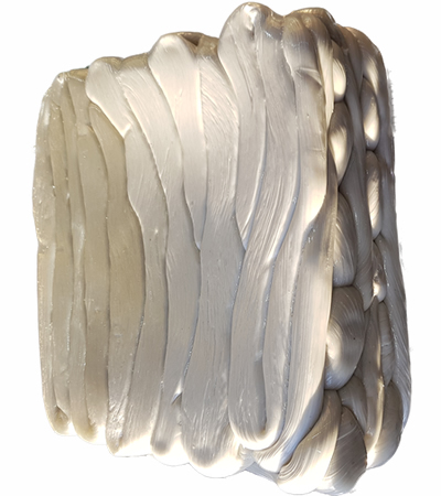 During shows compressed material being processed into dense putty-like form,