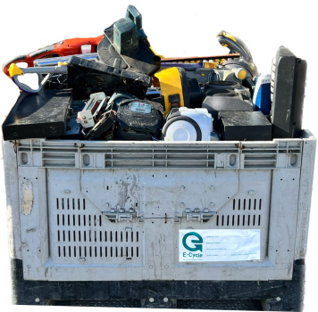 Industrial E-Cycle collection bin filled with mixed electronic waste including broken plastic components and electronics. Gray plastic container with ventilation slots and E-Cycle logo label contains sorted electronic materials for recycling and proper disposal.